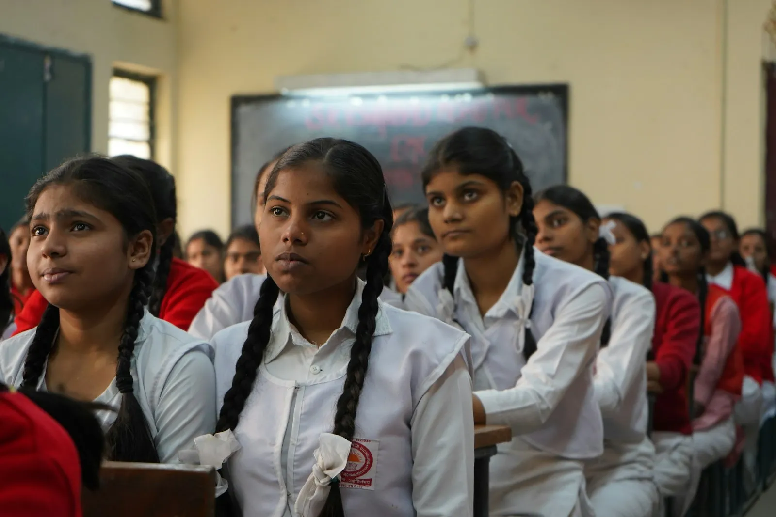 Students listening and participating in a classroom